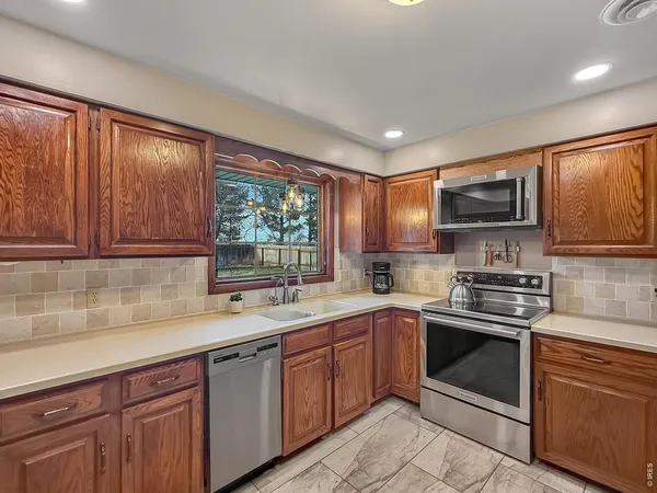 a kitchen with a sink stove top oven and cabinets