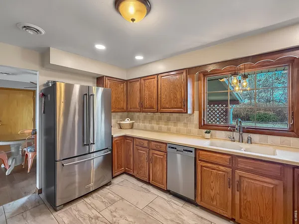 a kitchen with stainless steel appliances granite countertop a refrigerator sink and cabinets
