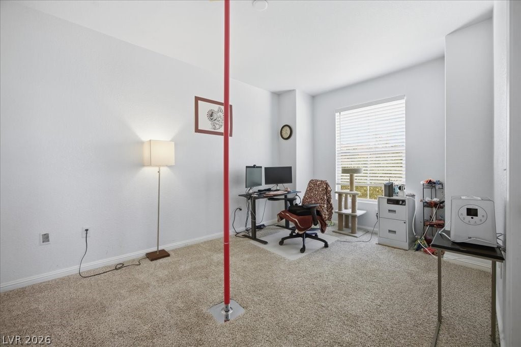 10550 West Alexander Road, Unit 2164 Las Vegas, NV 89129 - Photo 19 of 27 Well-lit room with ample natural light, featuring comfortable carpet flooring.