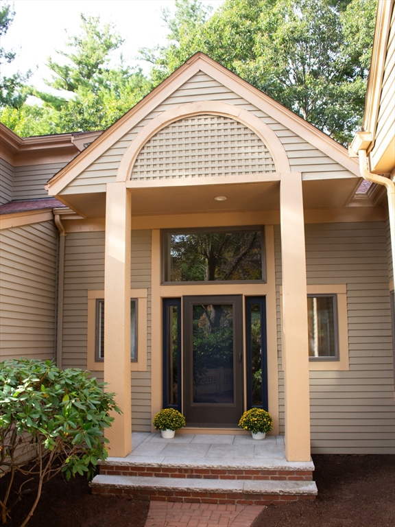 a front view of a house with garden