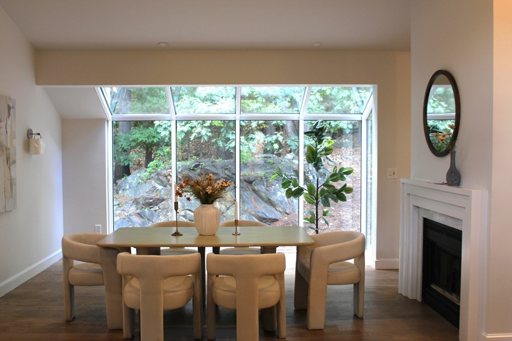 7 Wainwright Road, Unit 13 Winchester, MA 01890 - Photo 2 of 24 a dining room with furniture garden view and a fireplace