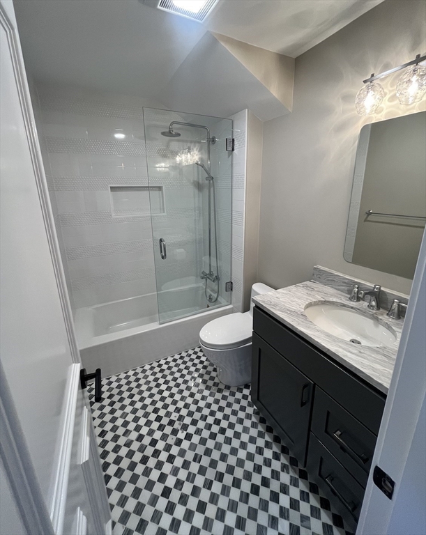 7 Wainwright Road, Unit 13 Winchester, MA 01890 - Photo 22 of 24 a bathroom with a sink a toilet a mirror and shower
