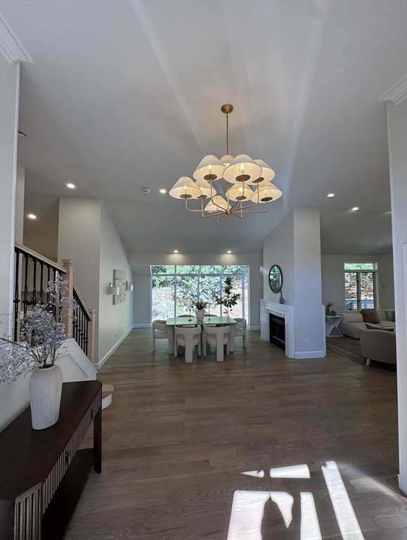 7 Wainwright Road, Unit 13 Winchester, MA 01890 - Photo 3 of 24 a view of a dining room and livingroom with furniture wooden floor a chandelier