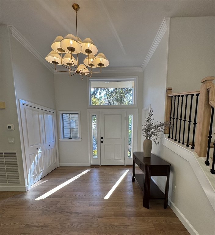 7 Wainwright Road, Unit 13 Winchester, MA 01890 - Photo 5 of 24 a view of a dining room with furniture wooden floor and chandelier
