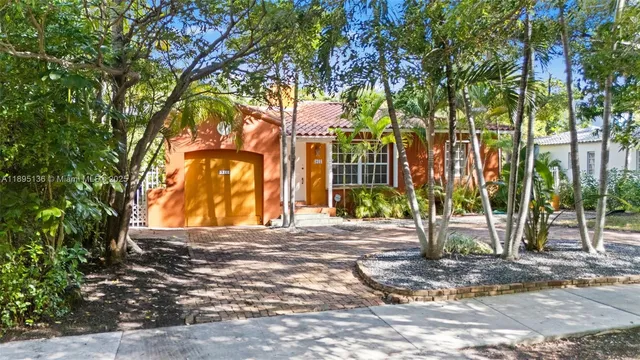 a view of a house with a tree in front