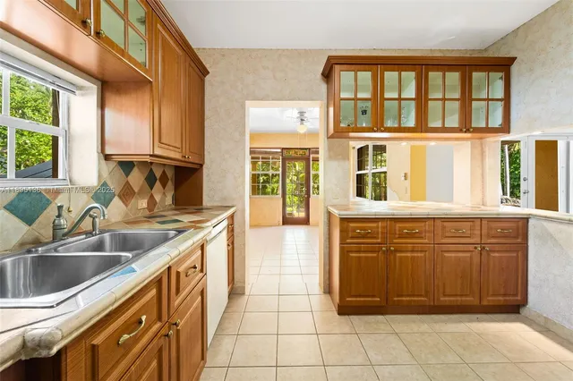 a kitchen with granite countertop a sink and a stove