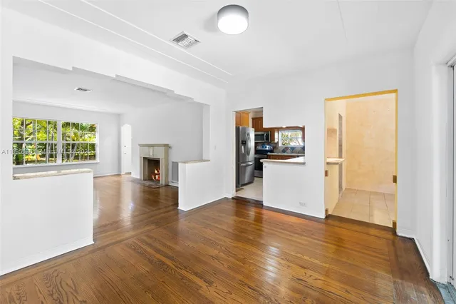 a view of a kitchen and an entryway with wooden floor