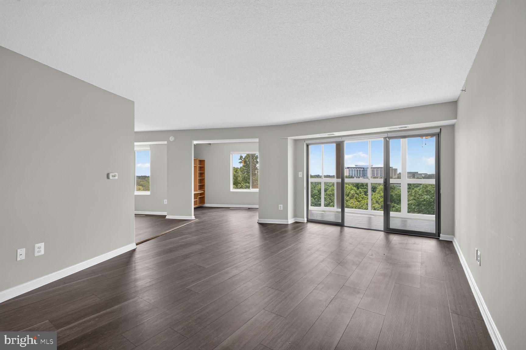 19385 Cypress Ridge Terrace, Unit 903 Leesburg, VA 20176 - Photo 12 of 37 Living room view onto the sunroom balcony