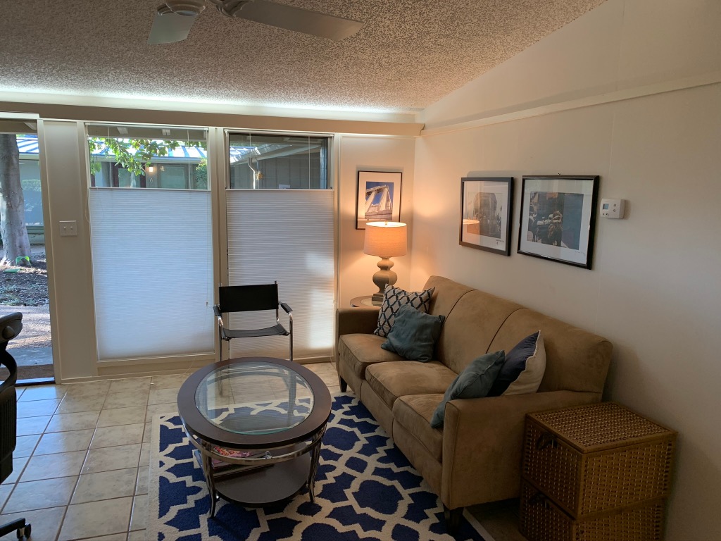 1714 Summit View Place, Unit 3 Austin, TX 78703 - Photo 14 of 17 Living area featuring vaulted ceiling, a textured ceiling, a ceiling fan, and tile patterned floors