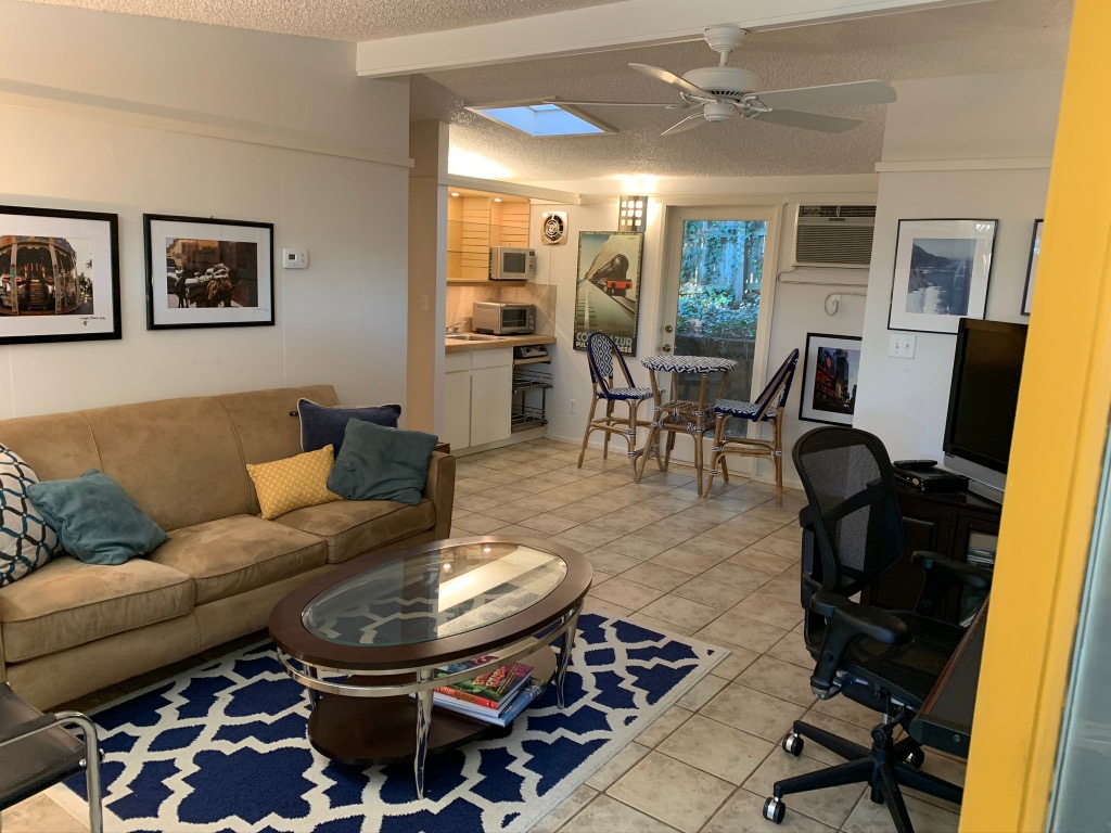 1714 Summit View Place, Unit 3 Austin, TX 78703 - Photo 3 of 17 Living area featuring light tile patterned floors, a wall mounted air conditioner, ceiling fan, and a textured ceiling