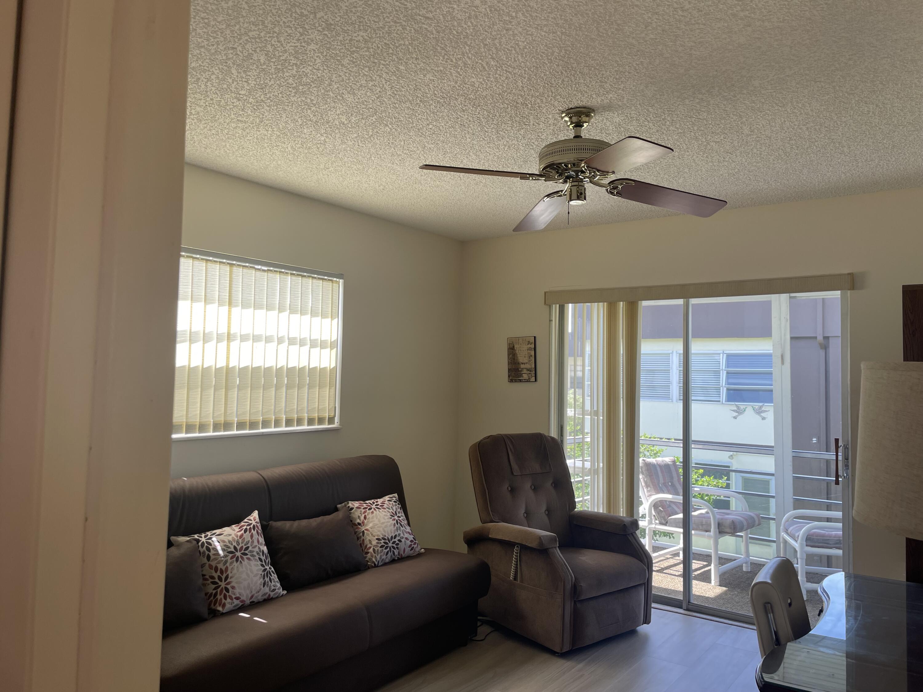 705 Normandy Lane, Unit 705 Delray Beach, FL 33484 - Photo 19 of 37 a living room with furniture and a window