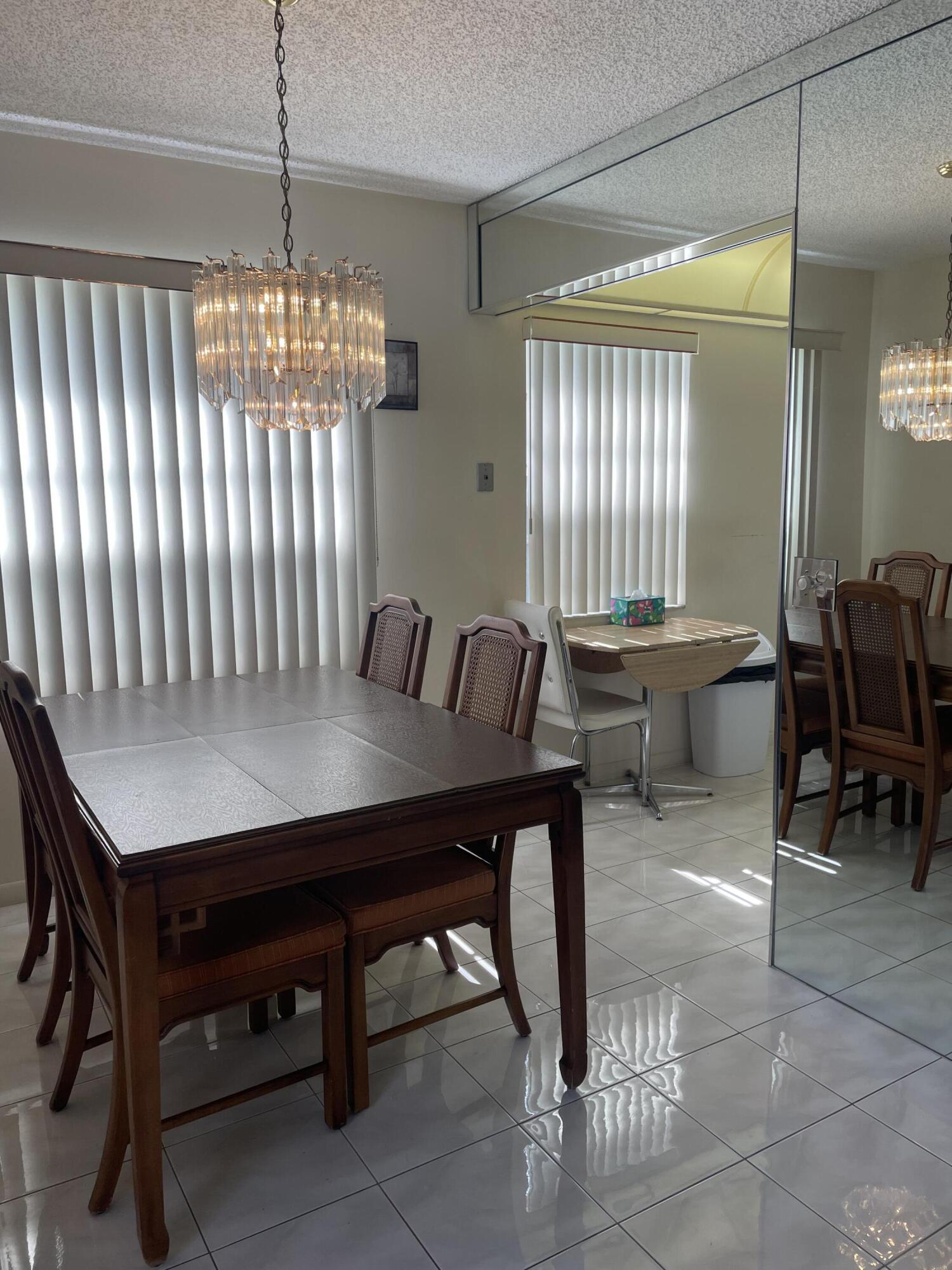 705 Normandy Lane, Unit 705 Delray Beach, FL 33484 - Photo 8 of 37 a view of a dining room with furniture window and outside view