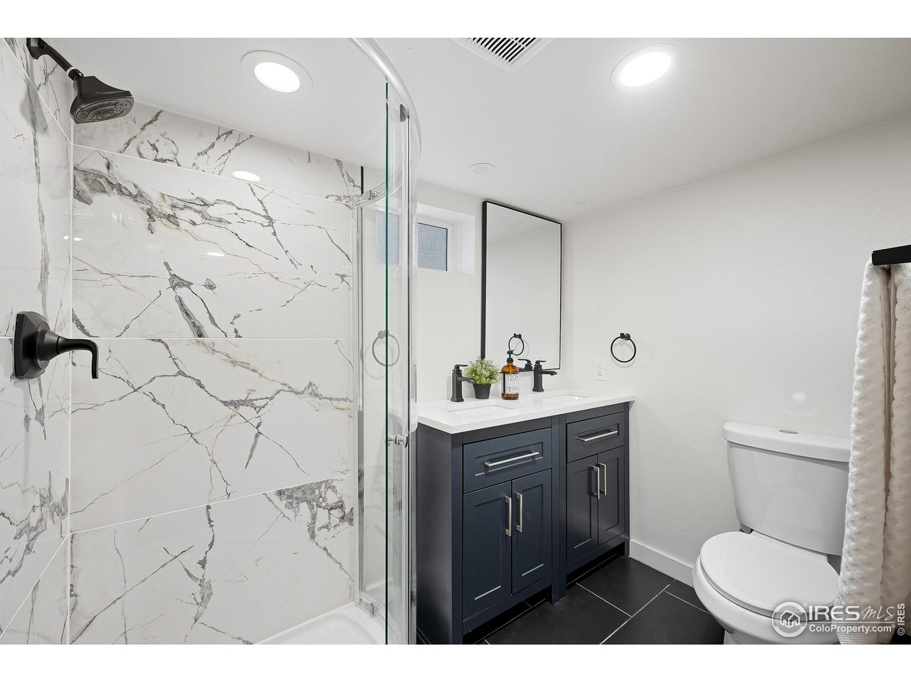 200 Bishop Street Fort Collins, CO 80521 - Photo 19 of 32 a bathroom with a granite countertop sink toilet a mirror and shower