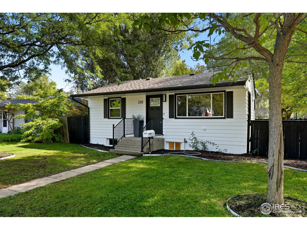 200 Bishop Street Fort Collins, CO 80521 - Photo 2 of 32 a view of a backyard with table and chairs and large tree