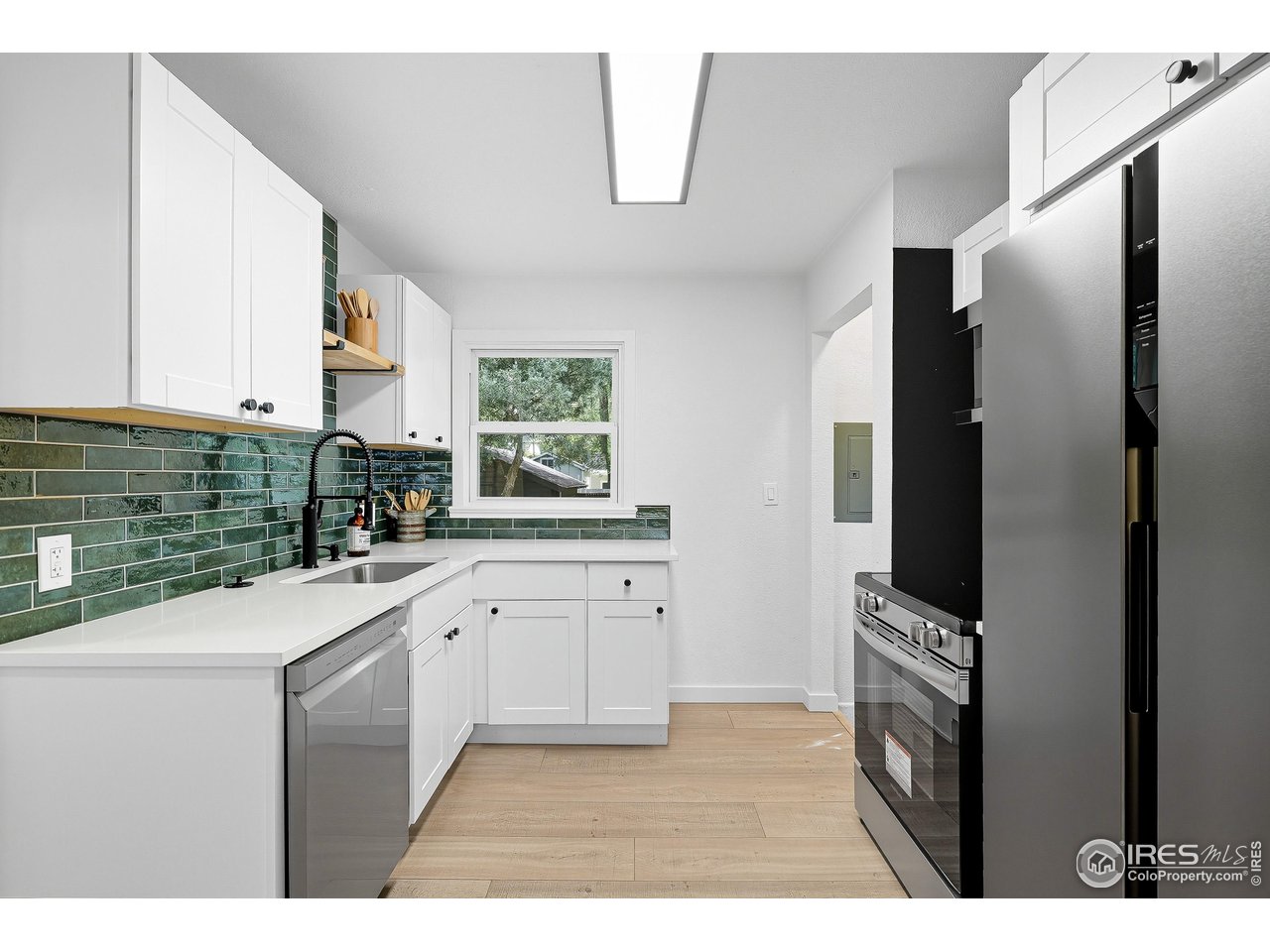 200 Bishop Street Fort Collins, CO 80521 - Photo 10 of 32 a kitchen with stainless steel appliances a refrigerator sink and cabinets