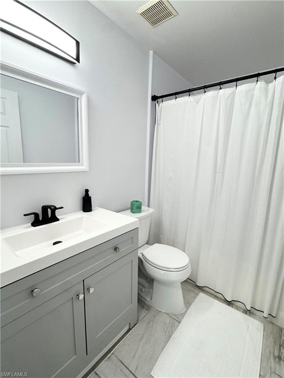 1190 Reserve Way, Unit 304 Naples, FL 34105 - Photo 13 of 20 a bathroom with a sink and a mirror