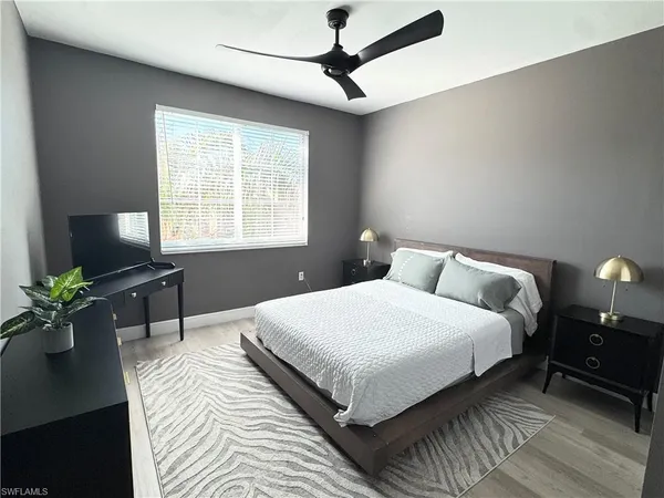 a bedroom with bed furniture and a window