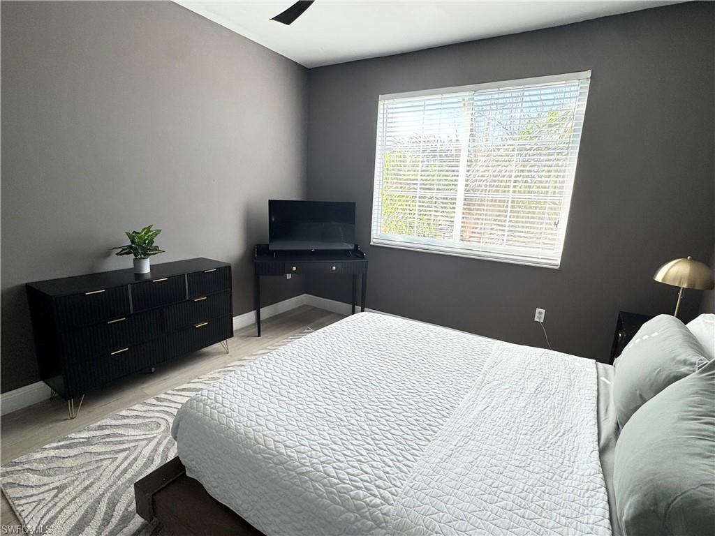 1190 Reserve Way, Unit 304 Naples, FL 34105 - Photo 16 of 20 a bedroom with a bed and a dressers