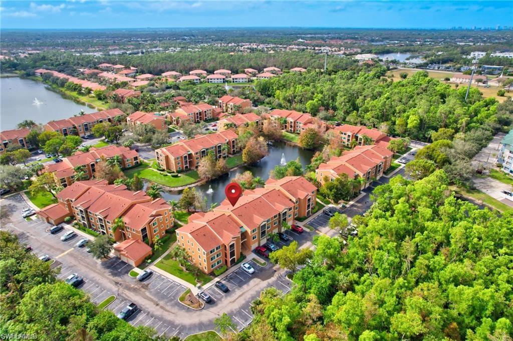 1190 Reserve Way, Unit 304 Naples, FL 34105 - Photo 20 of 20 an aerial view of residential houses with outdoor space and trees
