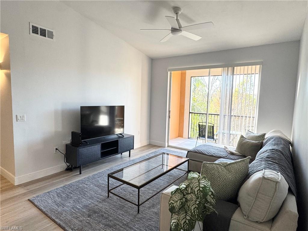 1190 Reserve Way, Unit 304 Naples, FL 34105 - Photo 3 of 20 a living room with furniture and a flat screen tv