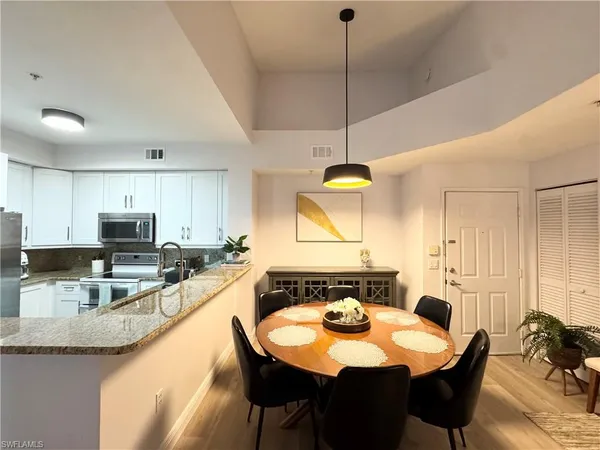 a large kitchen with a table and chairs