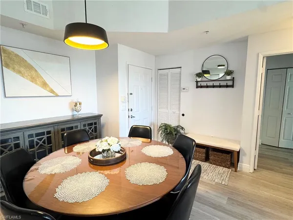a kitchen with dining table and a chandelier