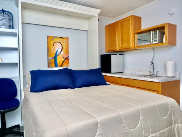 a bedroom with a bed and dresser