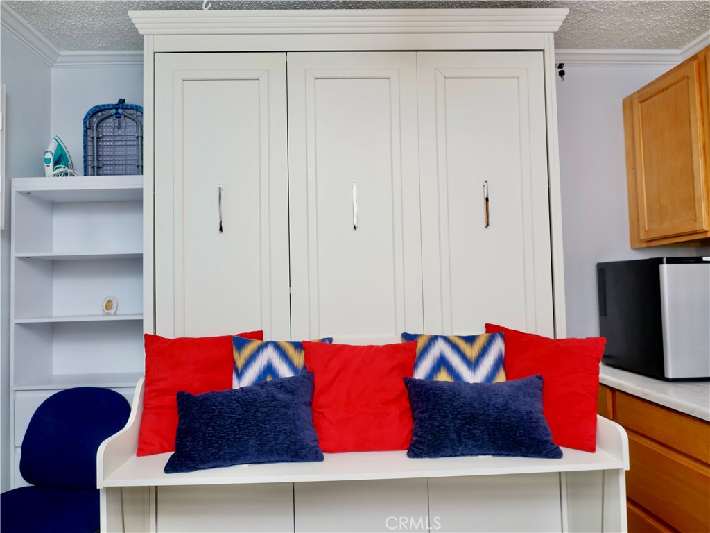 1220 West 56th Street Los Angeles, CA 90037 - Photo 3 of 5 a living room with furniture and a lamp