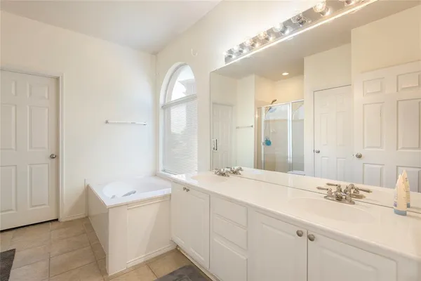 a bathroom with a double vanity sink mirror and
