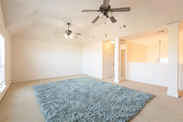 an empty room with fan and a ceiling fan