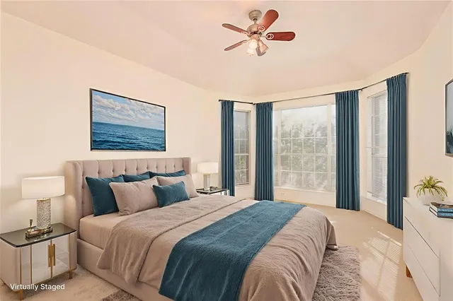 a bedroom with a large bed and a window