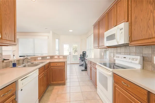 a kitchen with a sink stove and cabinets