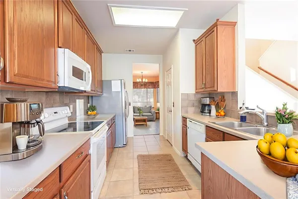a kitchen with stainless steel appliances granite countertop a lot of cabinets a sink and a counter space