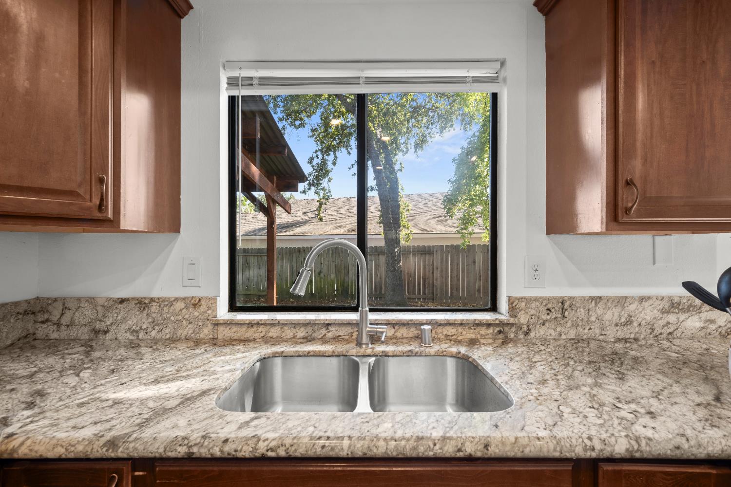 6427 Wittenham Way Orangevale, CA 95662 - Photo 17 of 51 a view of a kitchen sink a faucet a microwave and cabinets