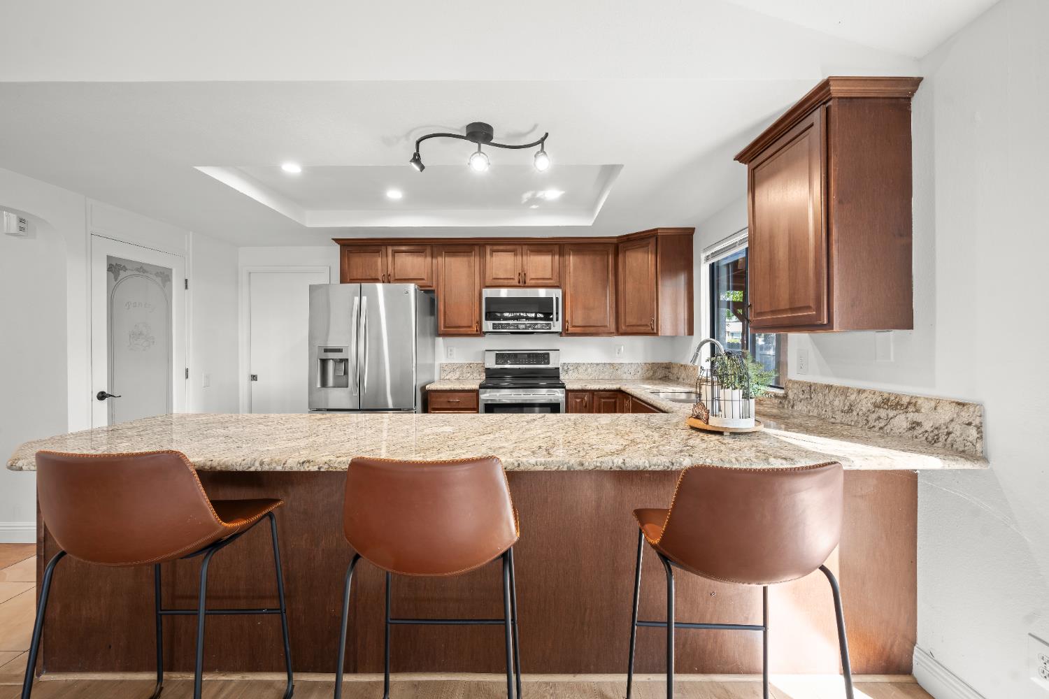 6427 Wittenham Way Orangevale, CA 95662 - Photo 18 of 51 a kitchen with stainless steel appliances granite countertop a stove top oven a refrigerator a sink and chairs