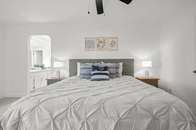 a bedroom with a bed and ceiling fan