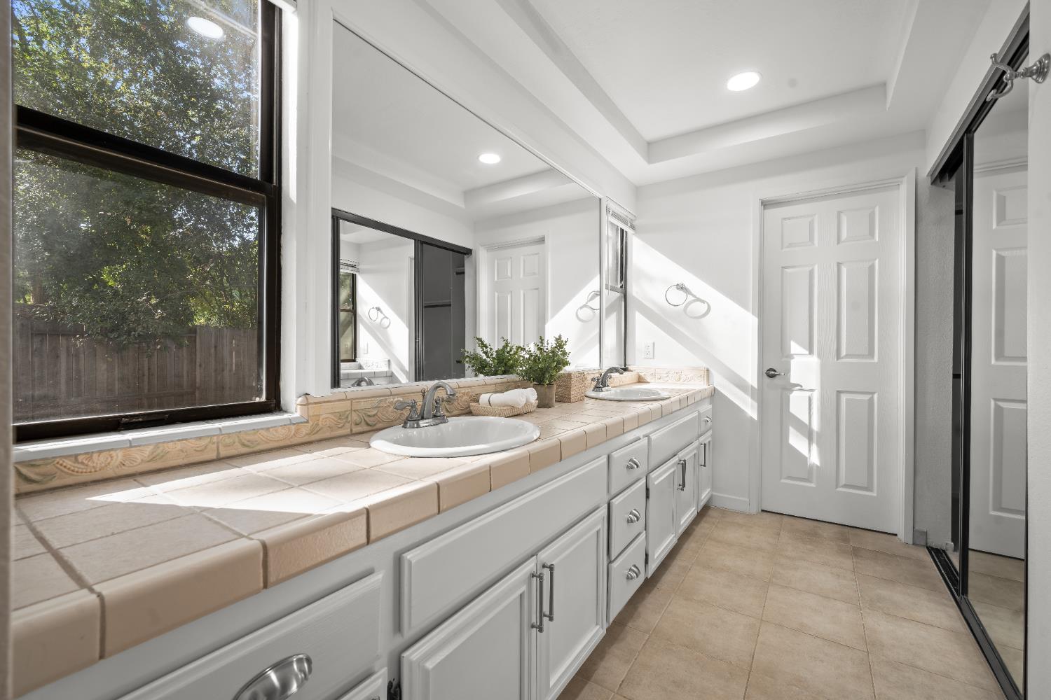 6427 Wittenham Way Orangevale, CA 95662 - Photo 27 of 51 a bathroom with a double vanity sink and a large mirror