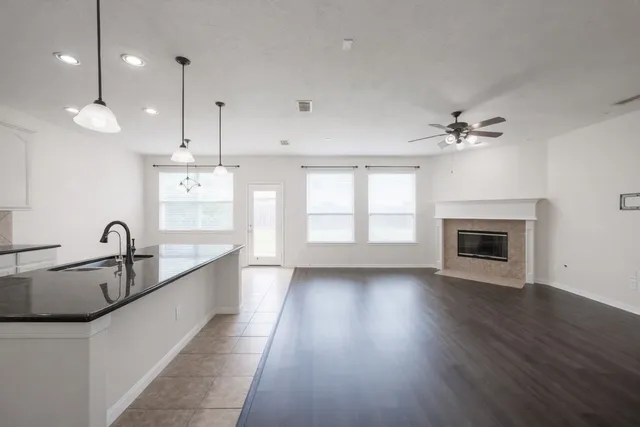 a view of a kitchen with a sink and a fireplace