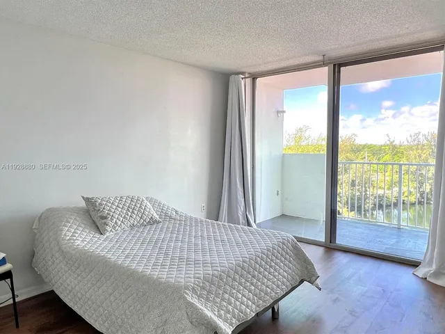 a bedroom with a bed and glass door