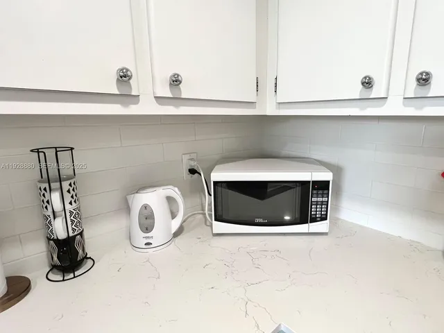 a bathroom with a sink and a washing machine