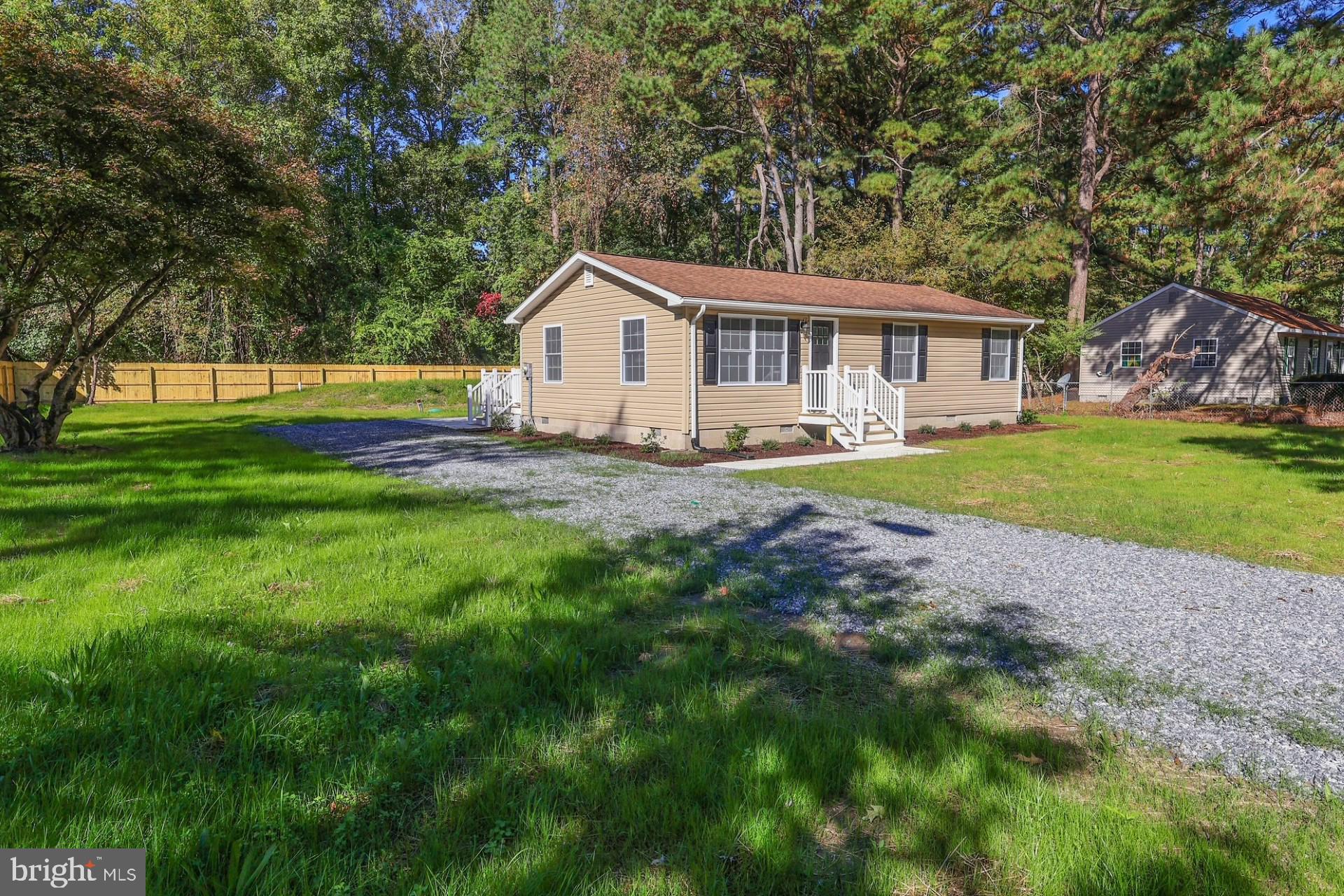 a view of a house with a yard and sitting area