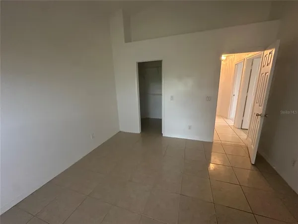 an empty room with a empty space and windows