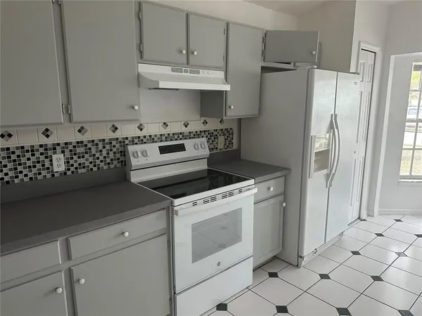 a kitchen with appliances cabinets and a sink