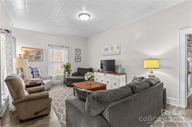 a living room with furniture a couch and a flat screen tv