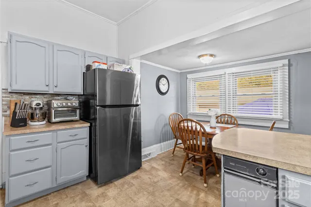a kitchen with stainless steel appliances granite countertop a refrigerator a stove a sink and a cabinets