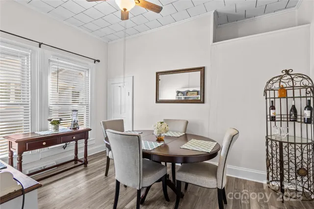 a view of a dining room with furniture window and wooden floor