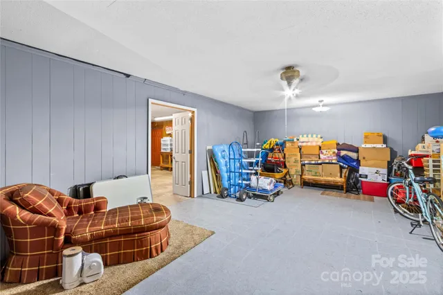 a living room with furniture a gym equipment and a flat screen tv