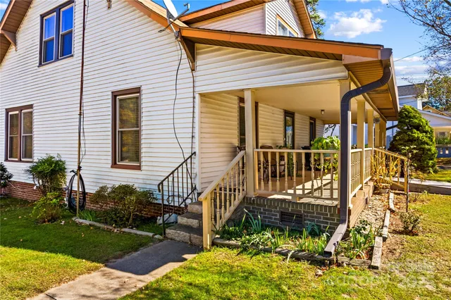 a view of a house with a small yard and a garden
