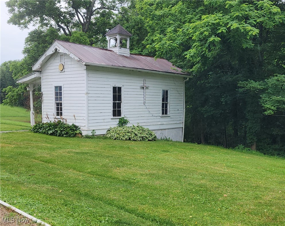 9090 Radcliffe Road Adamsville, OH 43802 - Photo 2 of 19 View of property exterior with a lawn