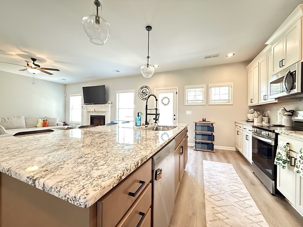 33 Sugar Maple Drive Fort Mitchell, AL 36856 - Photo 8 of 29 a large kitchen with kitchen island a sink stove and refrigerator